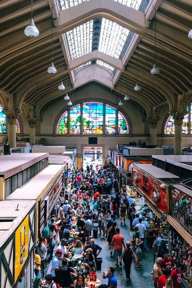Interior do Mercado Municipal de São Paulo com bancadas de frutas tropicais e especiarias